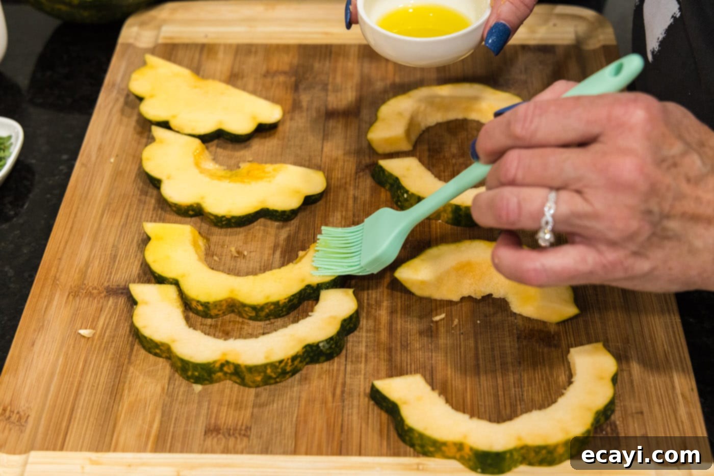 Delicious Air Fryer Acorn Squash 11 basting acorn squash slices with oil