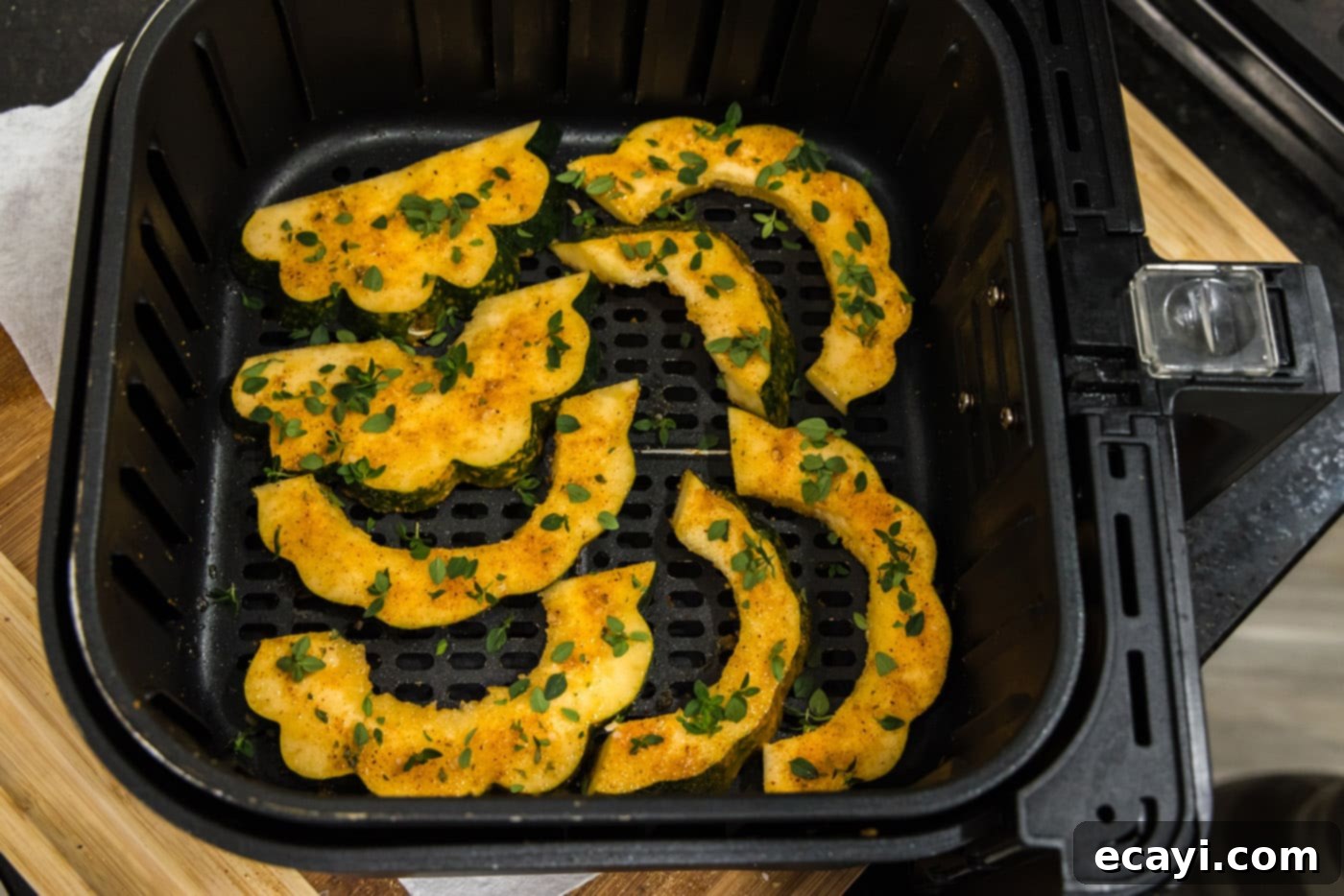 Delicious Air Fryer Acorn Squash 14 fresh thyme on top of roasted acorn squash slices
