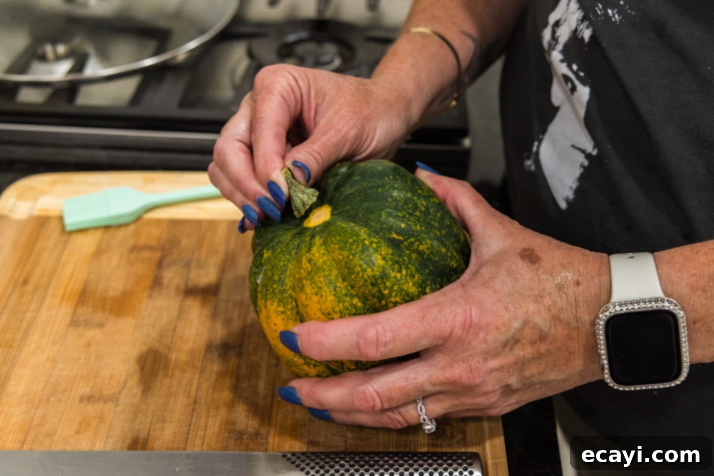 Delicious Air Fryer Acorn Squash 5 removing the stem from an acorn squash