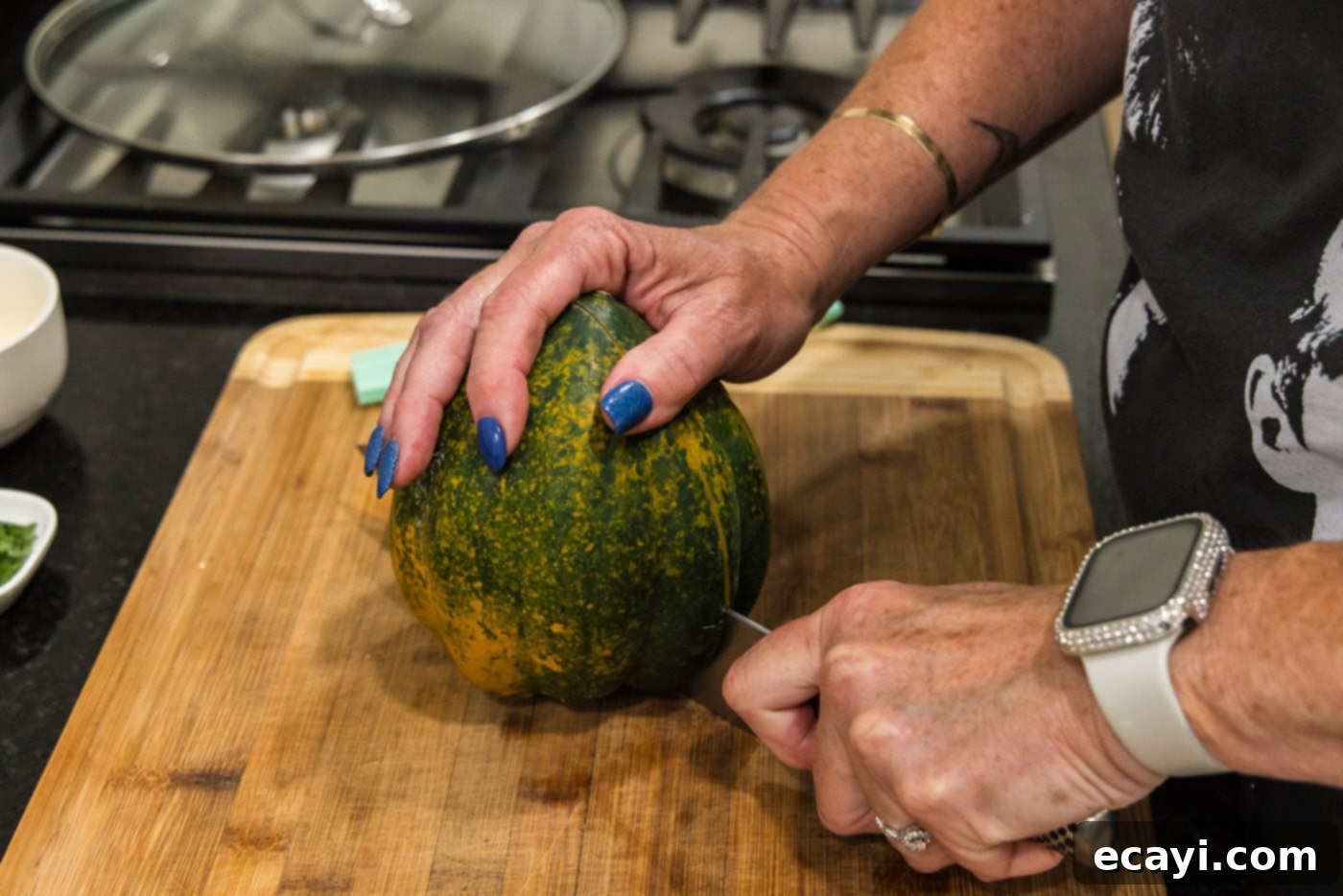 Delicious Air Fryer Acorn Squash 6 slicing an acorn squash in half