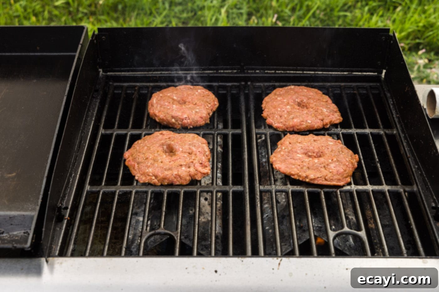 Smoky BBQ Bacon Burgers 10 burger patties cooking on a grill grate
