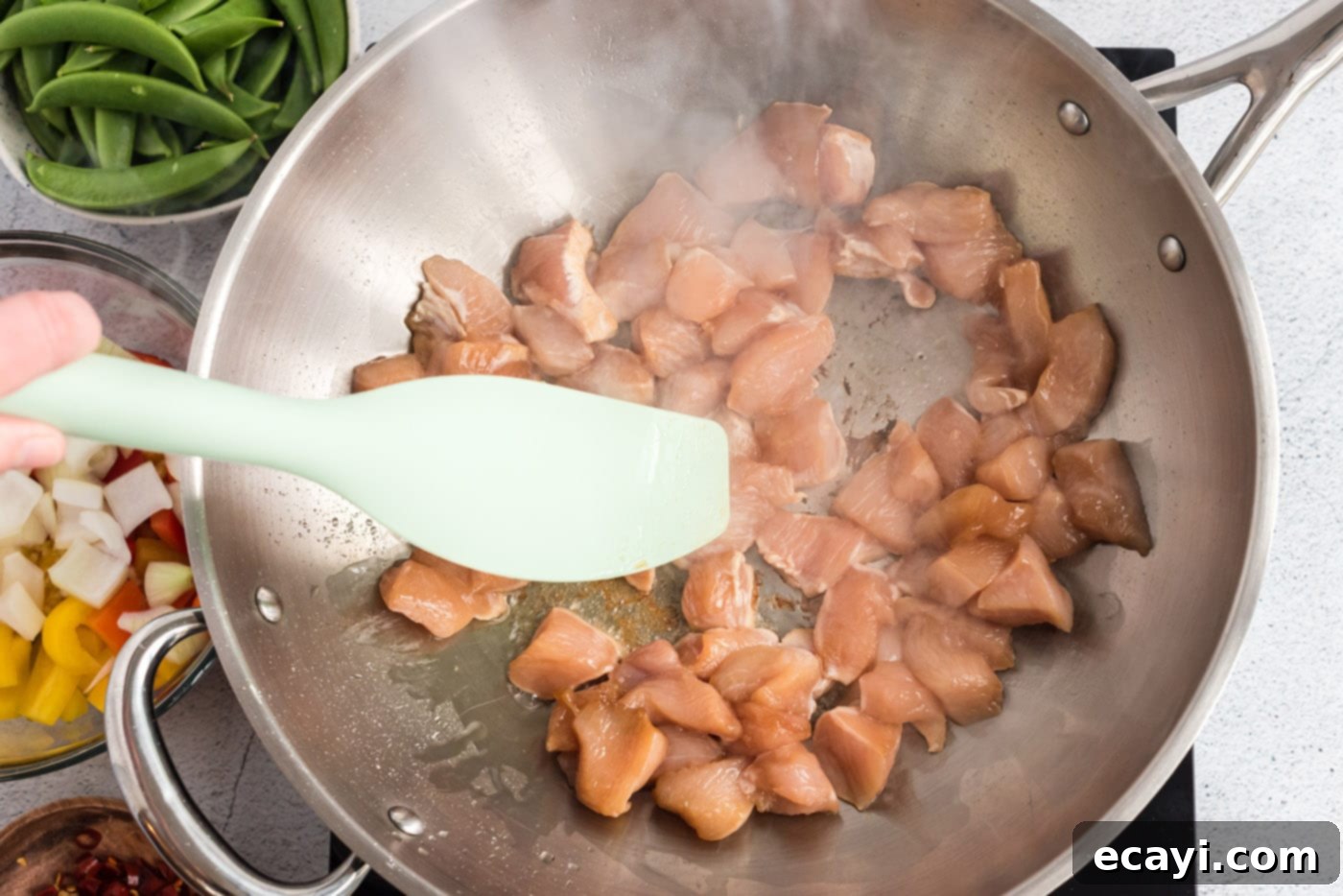 Spicy Szechuan Kung Pao Chicken 9 chicken in a wok pan frying
