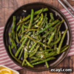 Crispy Air Fryer Green Beans 10 Air Fryer Green Beans on a sleek black plate, ready to be enjoyed.