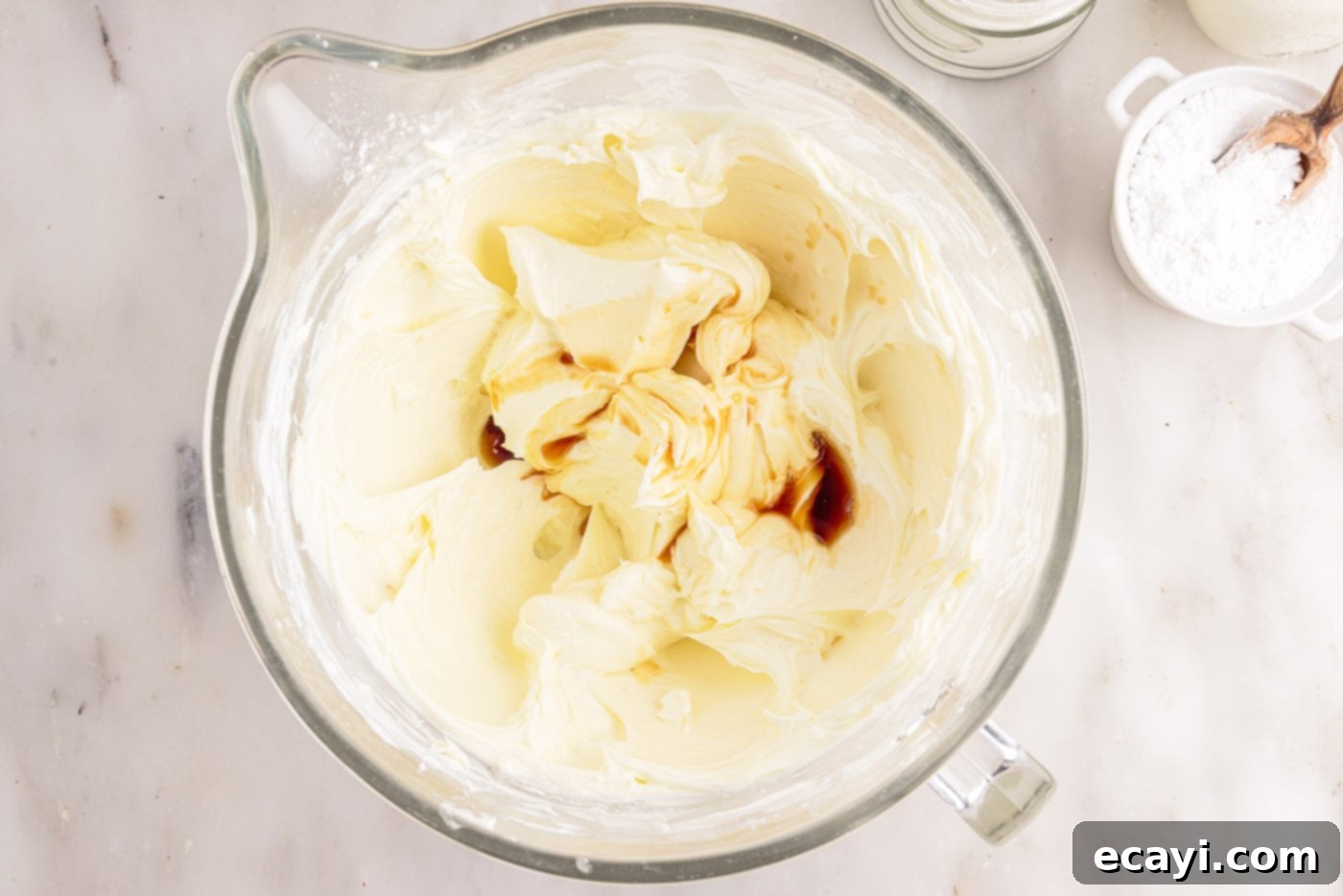 Decadent No-Bake Chocolate Cheesecake 12 adding vanilla to cream cheese mixture in a bowl