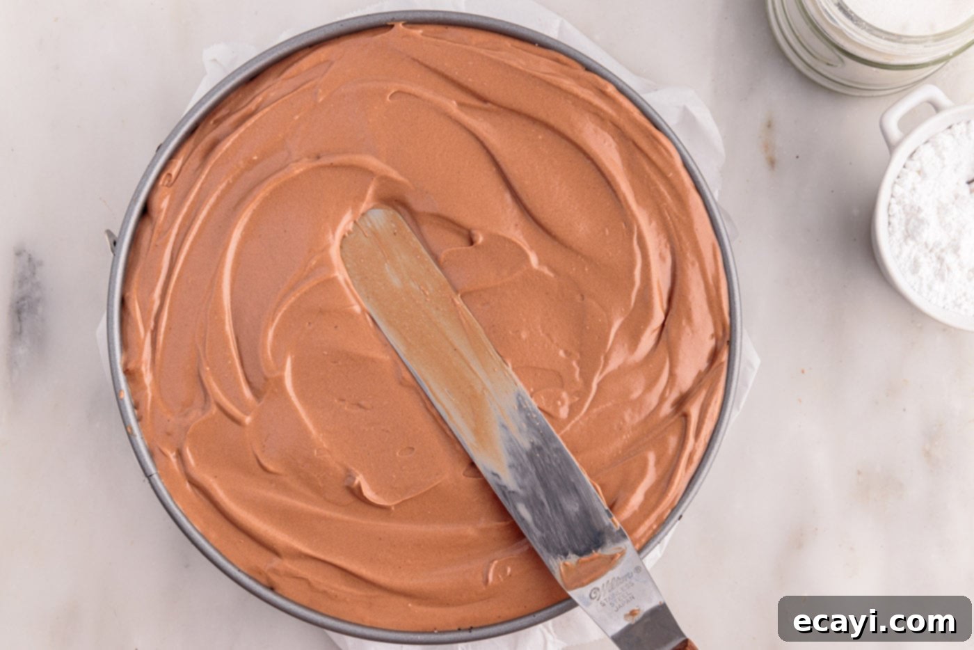 Decadent No-Bake Chocolate Cheesecake 17 smoothing no bake chocolate cheesecake mixture in a springform pan