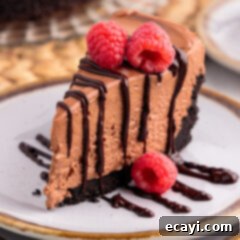 Decadent No-Bake Chocolate Cheesecake 21 Slice of No Bake Chocolate Cheesecake on a plate drizzled with chocolate ganache