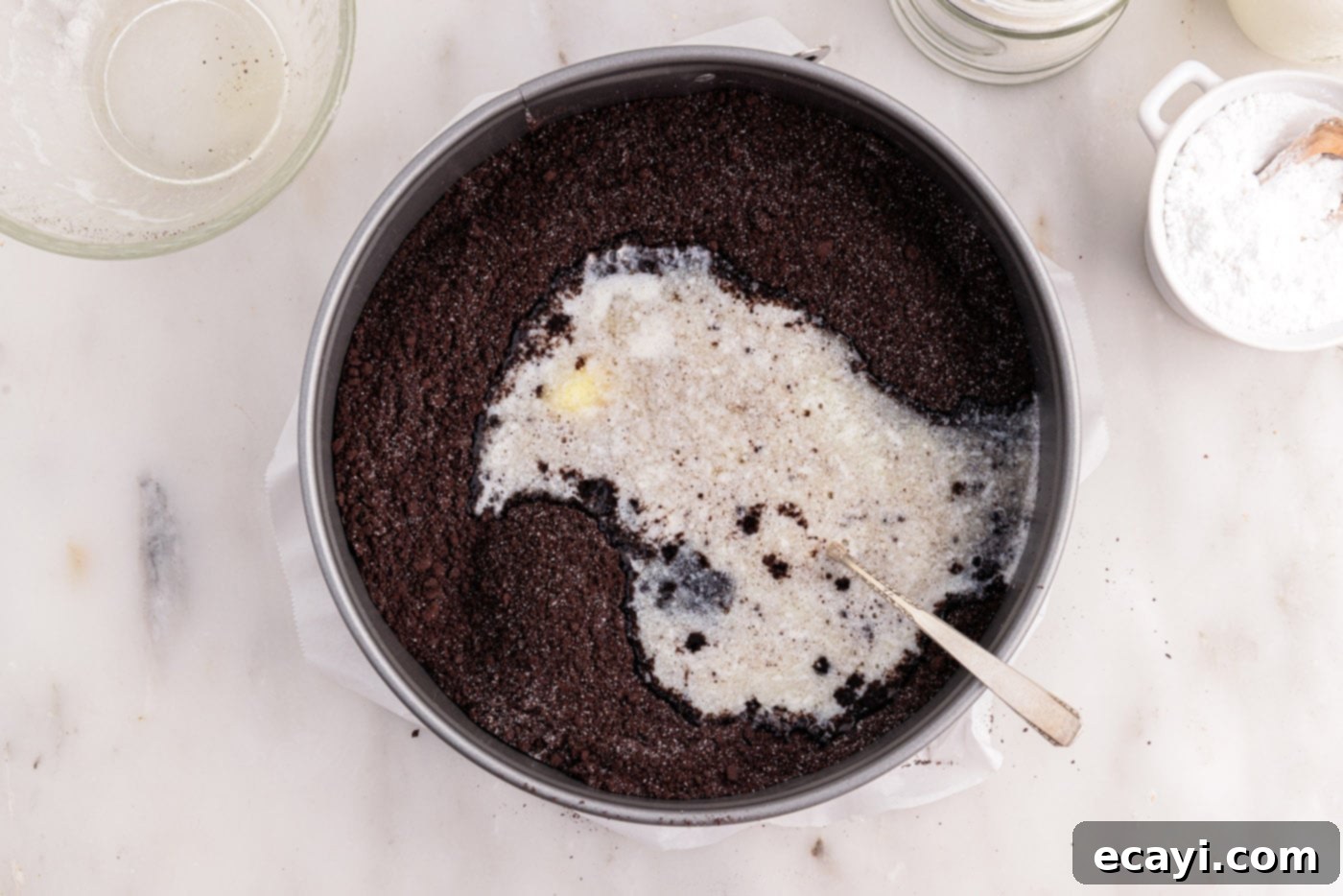 Decadent No-Bake Chocolate Cheesecake 8 mixing graham cracker crumbs with melted butter into a sandy mixture