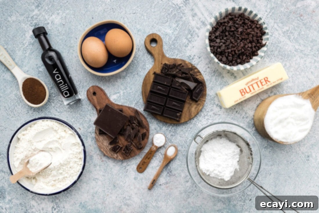 Decadent Espresso Fudge Brownies 4 Various ingredients for Fudge Frosted Espresso Brownies laid out on a surface, including chocolate, butter, sugar, and flour