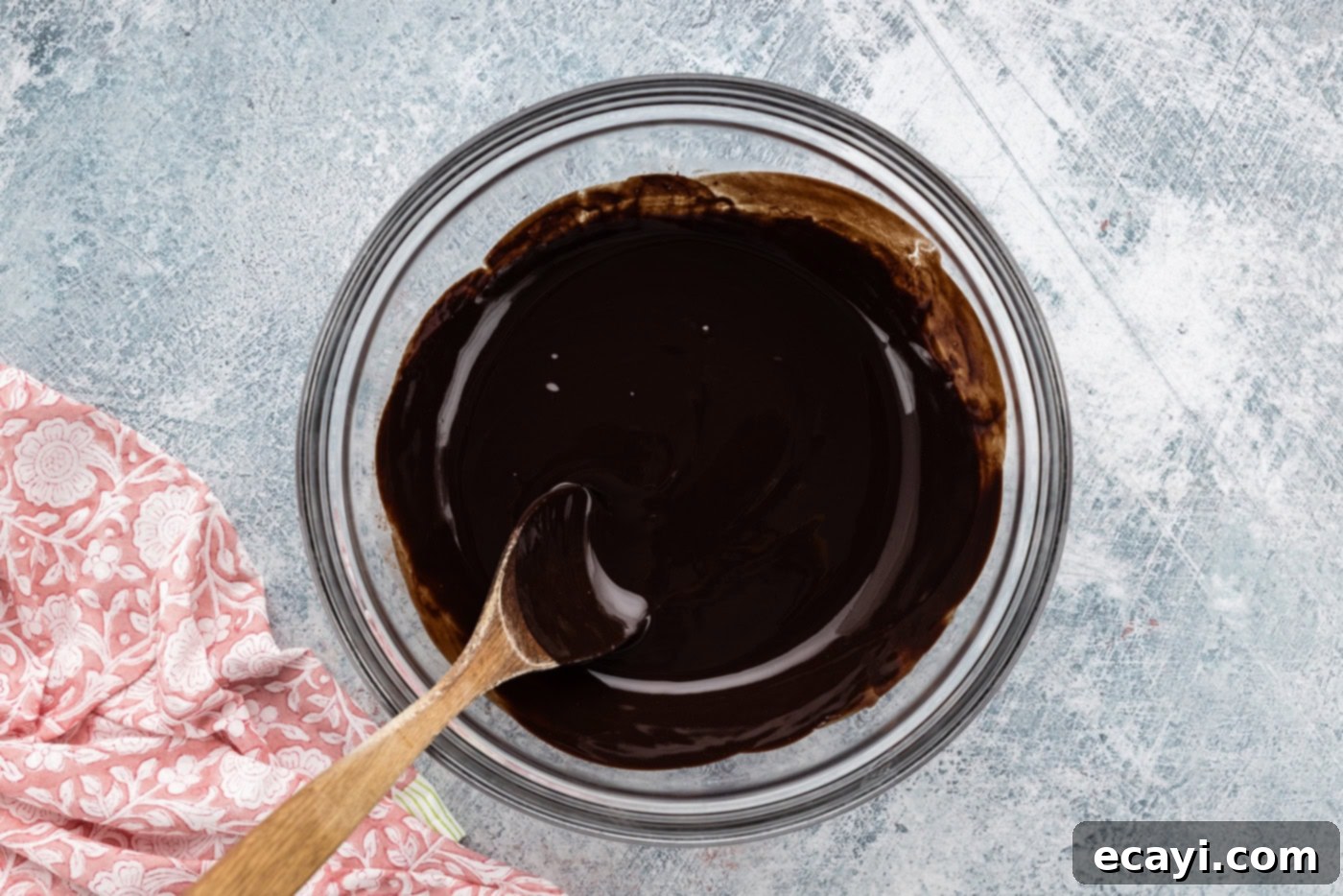 Decadent Espresso Fudge Brownies 5 Melted butter and two types of chocolate in a bowl, stirred smooth with a wooden spoon, ready for the next ingredients