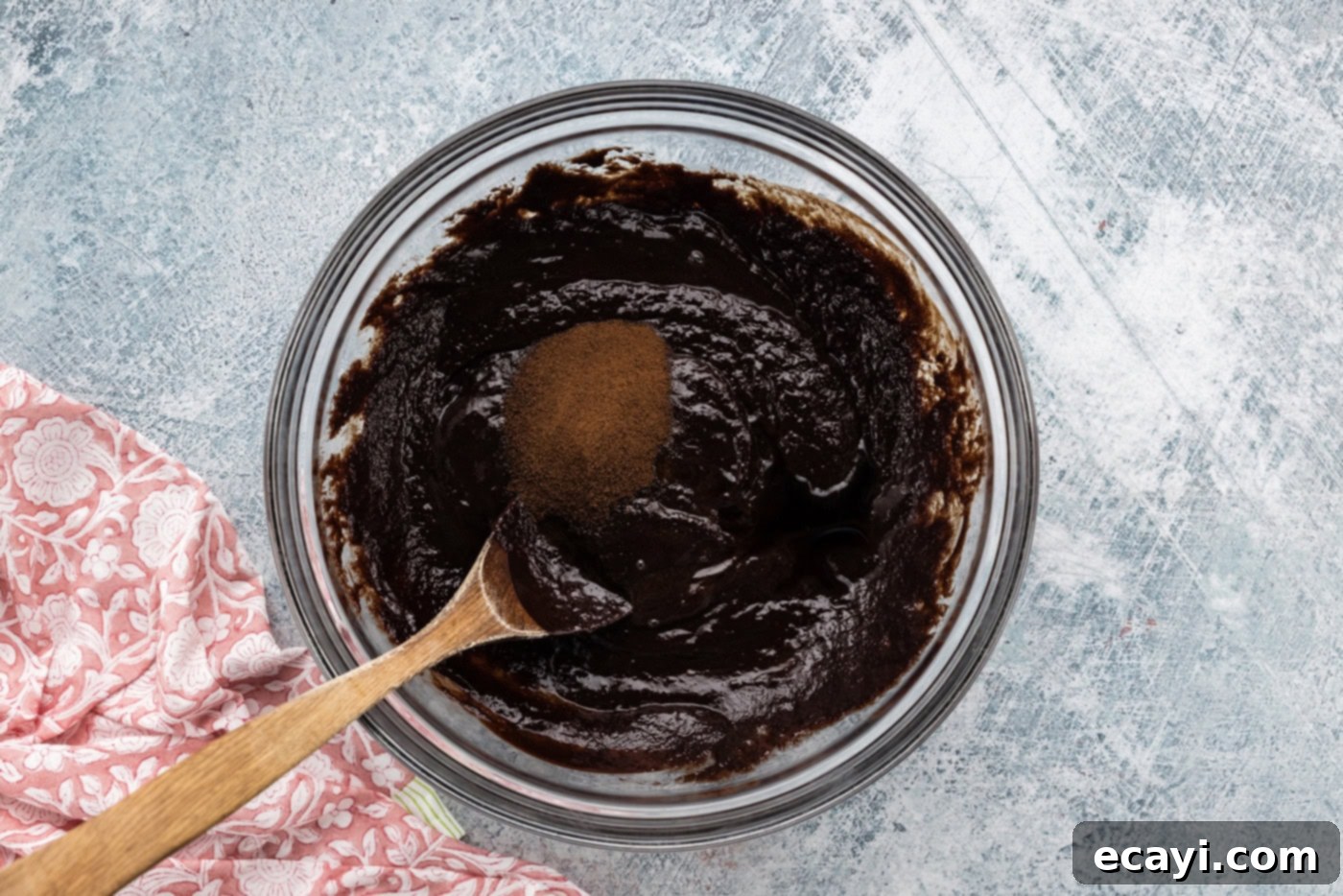 Decadent Espresso Fudge Brownies 6 Espresso powder and vanilla extract added to the chocolate brownie batter in a mixing bowl, ready to be stirred