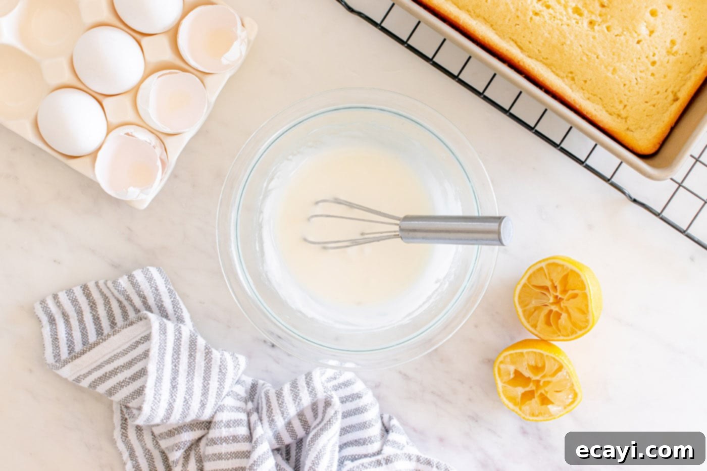 Zesty Lemon Loaf 13 lemon glaze in a bowl with a whisk