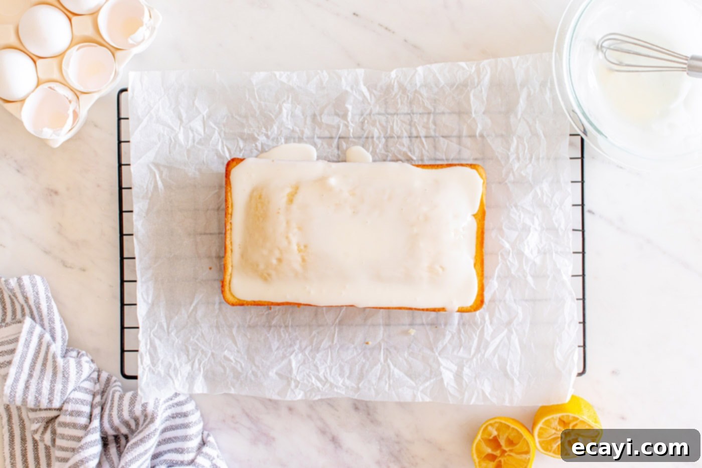 Zesty Lemon Loaf 14 iced lemon pound cake on parchment paper