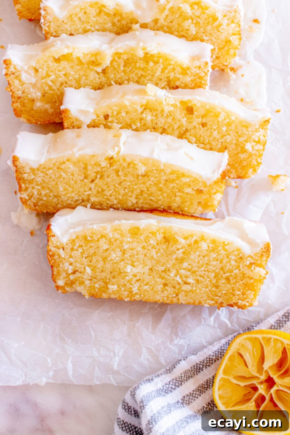 Zesty Lemon Loaf 3 Close-up photo of perfectly glazed slices of Lemon Pound Cake, showing off its moist texture.