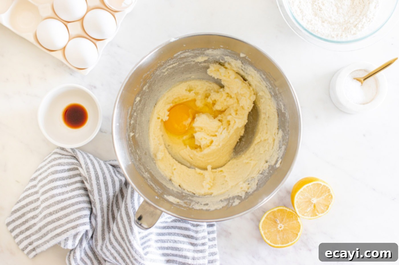 Zesty Lemon Loaf 7 adding eggs to beaten butter and sugar mixture in a stand mixer