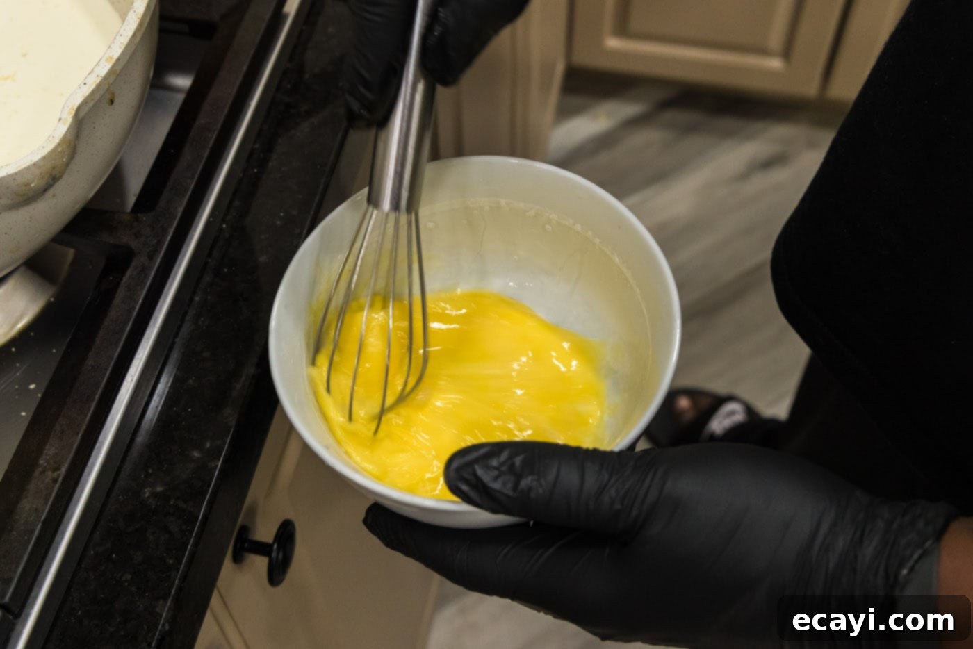 Smoked Turkey Carbonara 11 Whisking eggs in a glass bowl