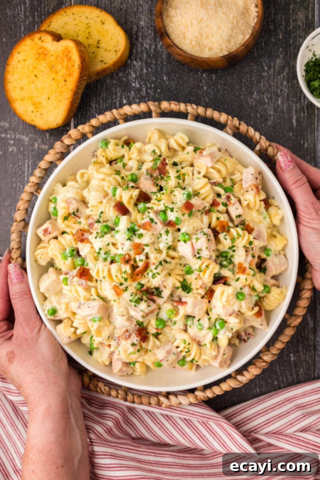 Smoked Turkey Carbonara 3 Hands holding a serving bowl of homemade Turkey Carbonara