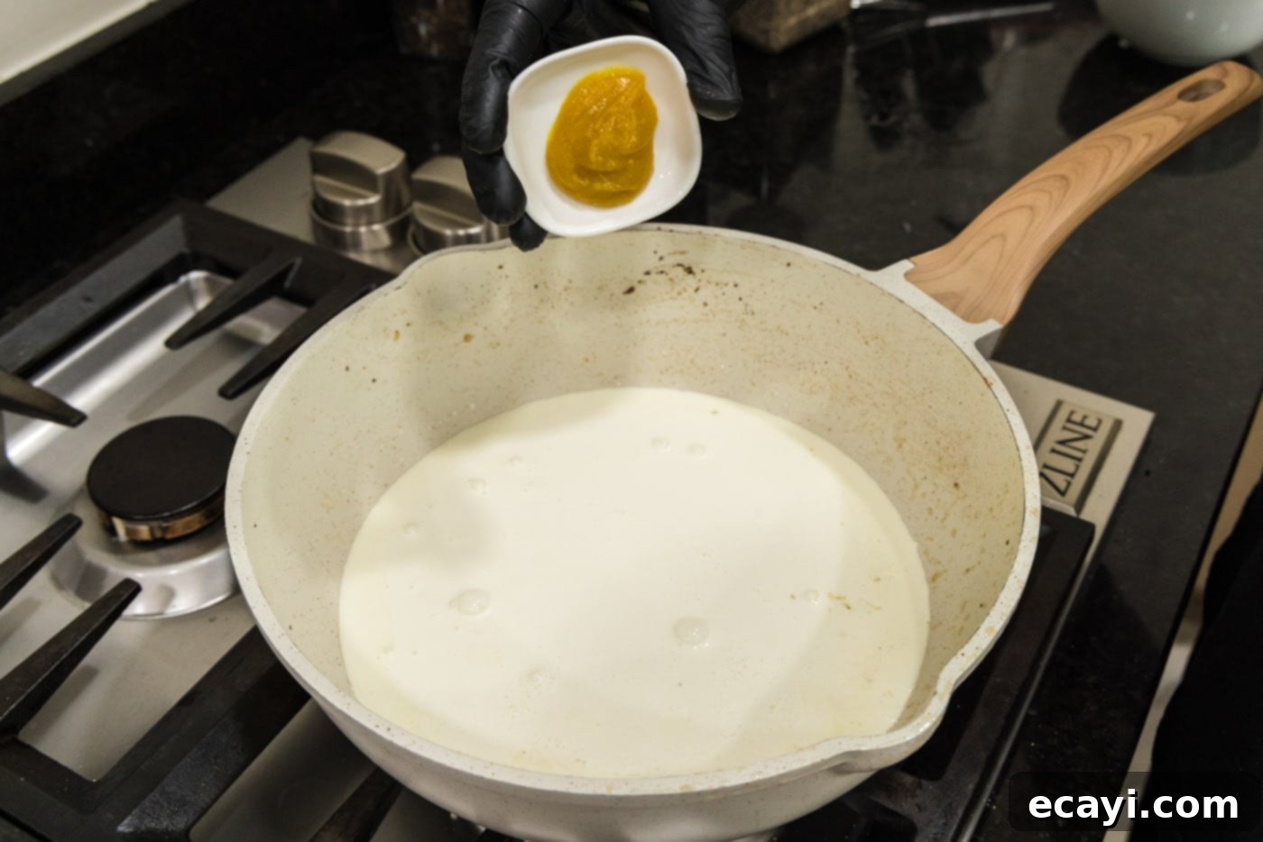 Smoked Turkey Carbonara 10 Adding chicken base to the heavy cream in the skillet, ready to whisk