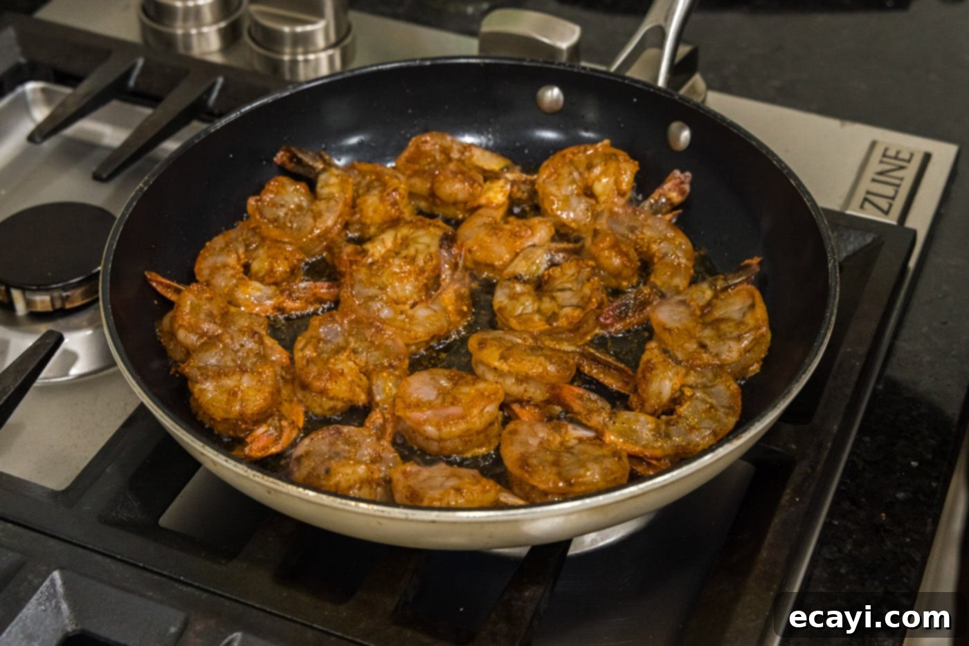 Fiery Prawns 8 seasoned shrimp in a skillet