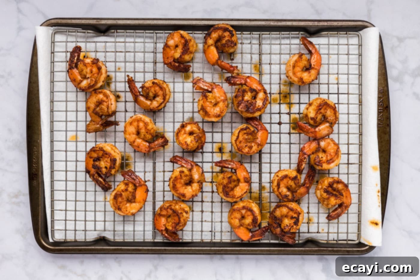 Fiery Prawns 10 cooked spicy shrimp resting on a wire rack