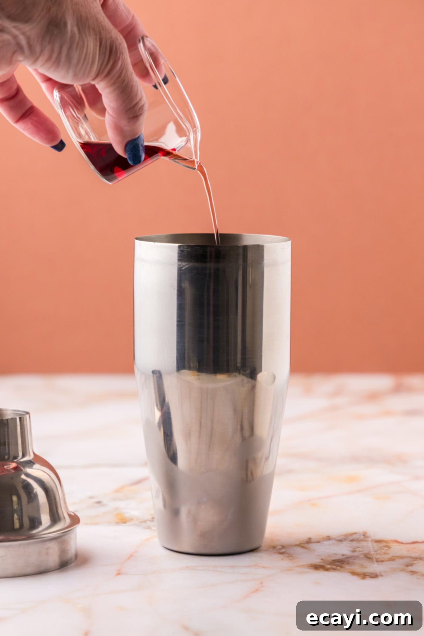 The Parisian Raspberry Sip 6 pouring chambord into cocktail shaker