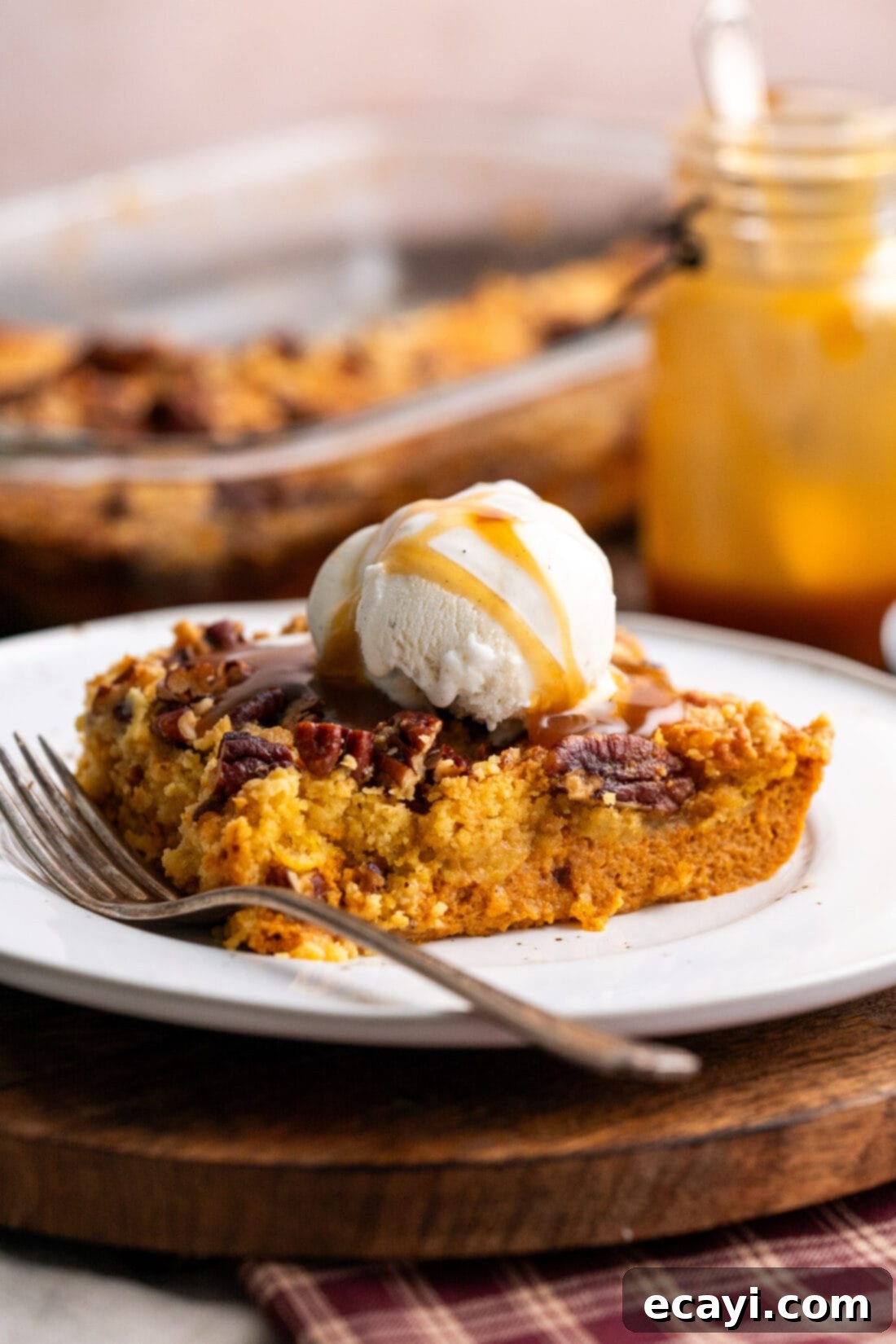 Effortless Pumpkin Spice Bake 2 Piece of Pumpkin Dump Cake on a plate with a fork