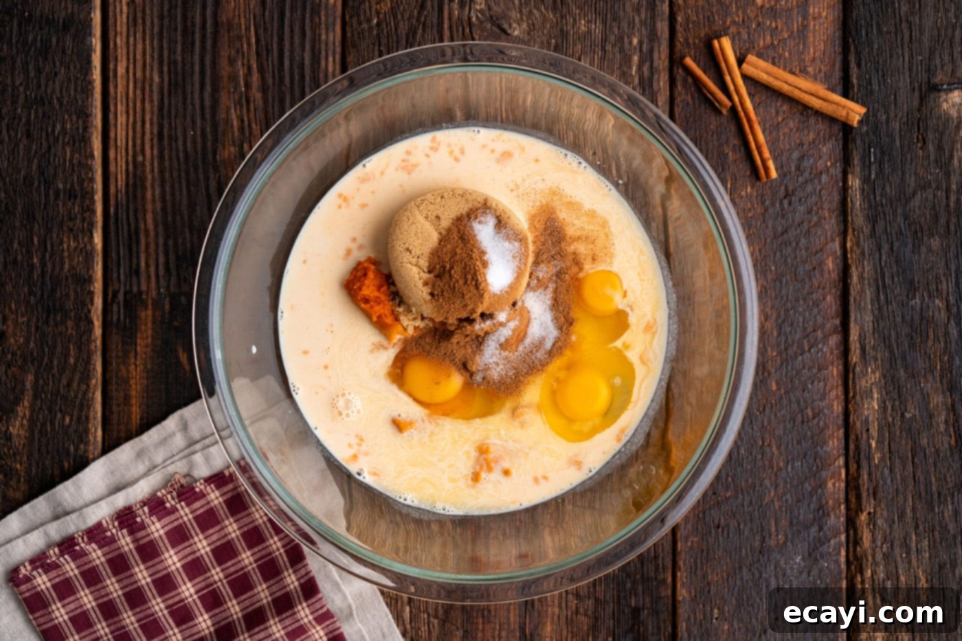 Effortless Pumpkin Spice Bake 5 eggs, sugar, and pumpkin puree in a bowl