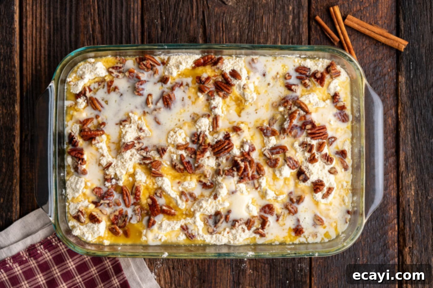 Effortless Pumpkin Spice Bake 9 melted butter drizzled over dump cake with pecans