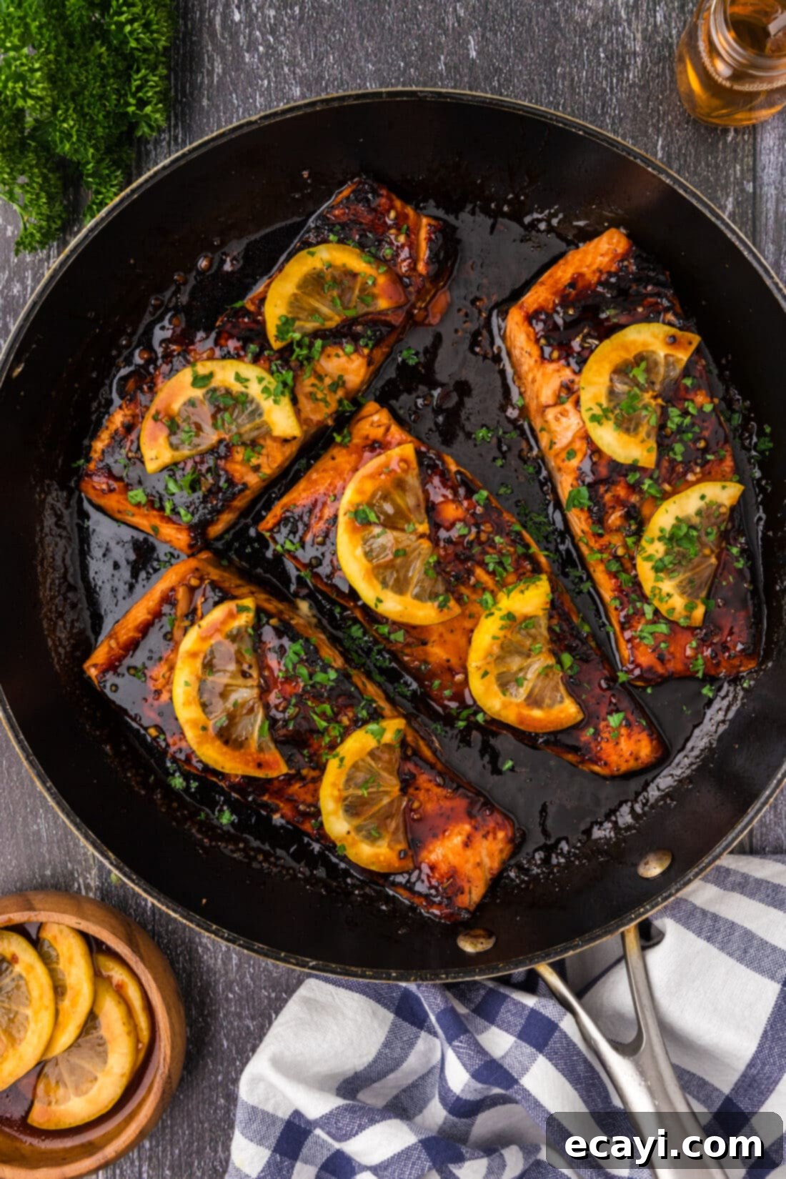 Caramelized Honey Salmon 2 Honey Salmon in a skillet topped with lemon slices