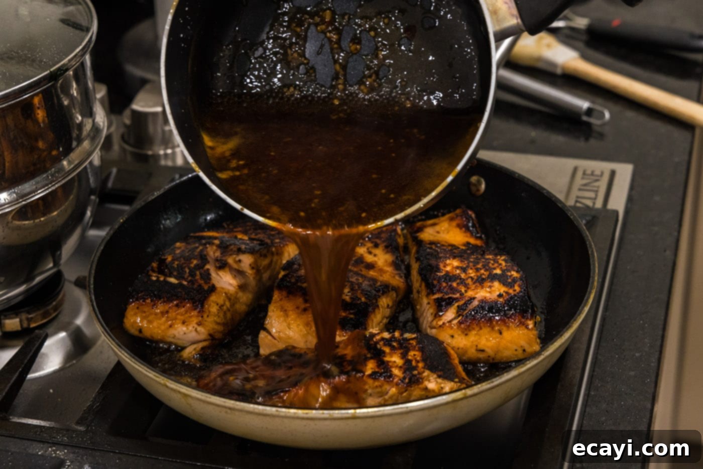 Caramelized Honey Salmon 13 pouring honey glaze over salmon filets in a skillet