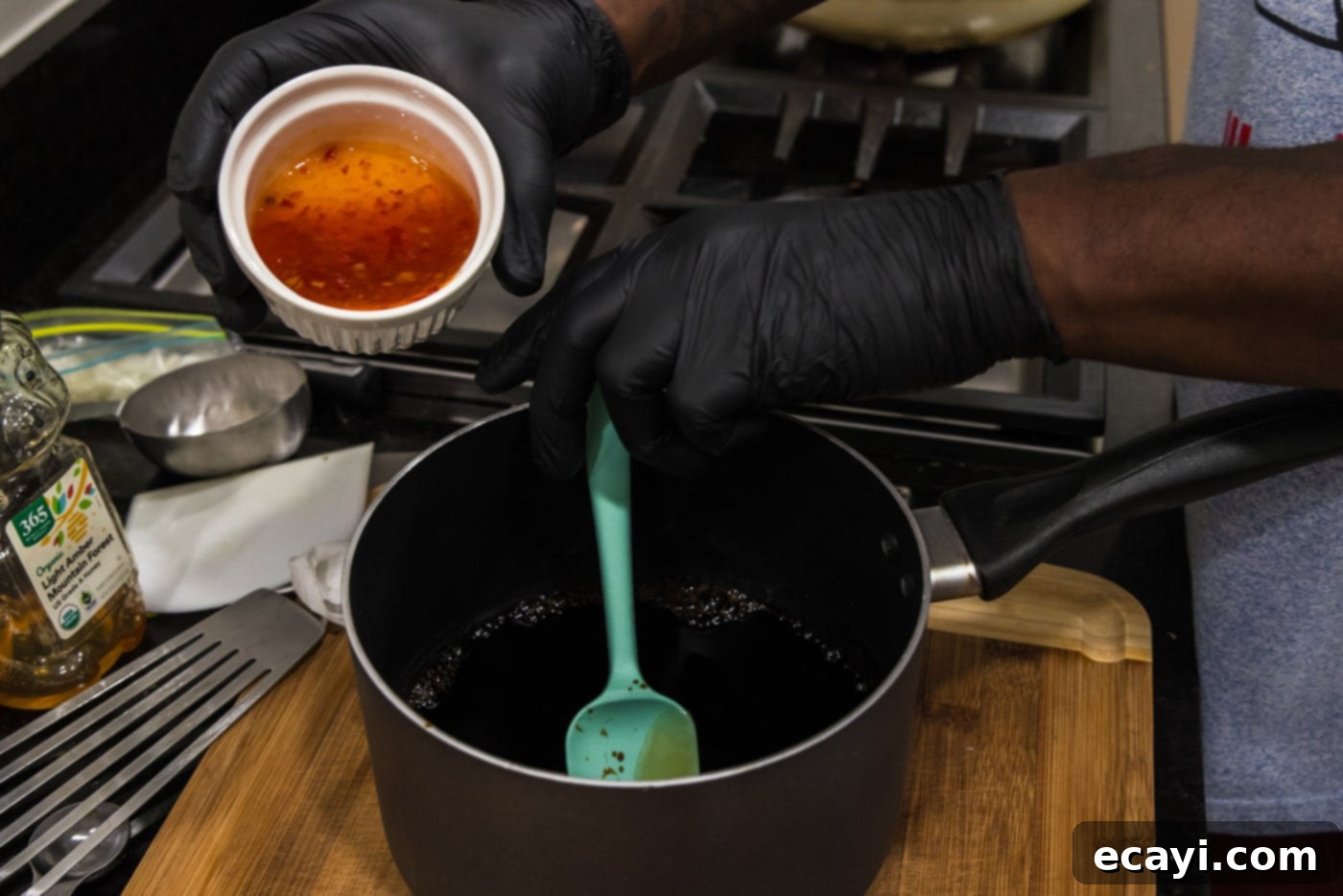 Caramelized Honey Salmon 6 pouring Asian sweet chili sauce into sauce pan