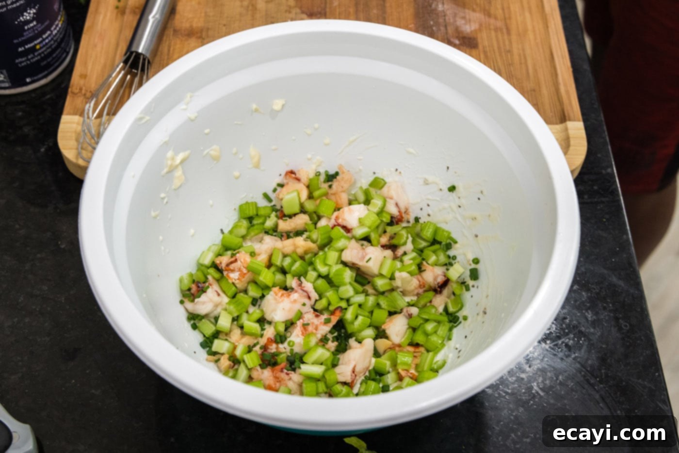 Classic Lobster Salad 8 diced celery added to lobster and dressing in a bowl
