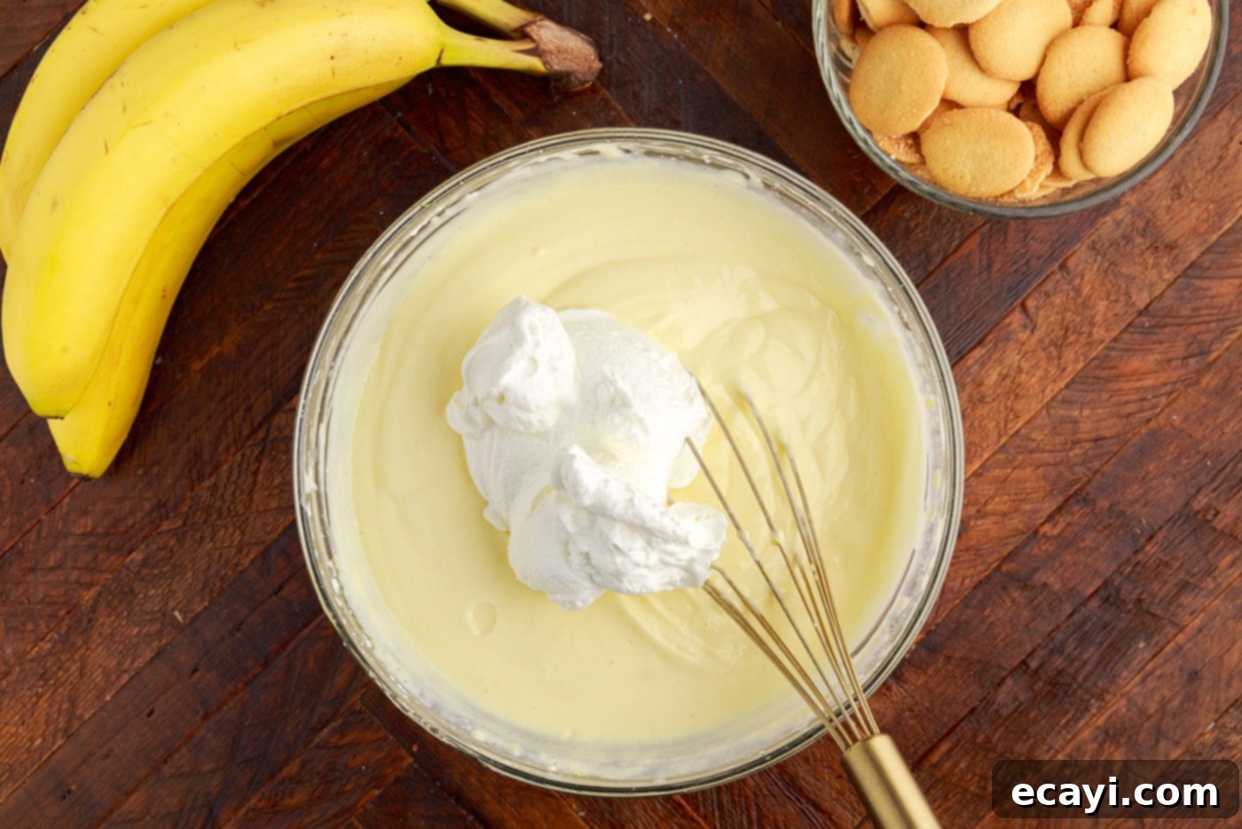Decadent Banana Layers 8 folding a dollop of whipped cream into cream cheese pudding mixture