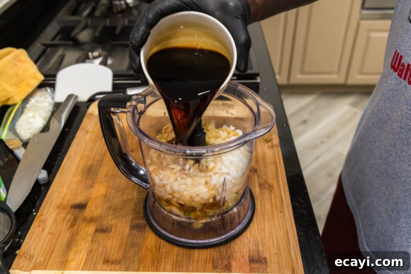 Fall-Off-The-Bone Korean Short Ribs 5 Pouring soy sauce into a food processor with other Korean marinade ingredients like pear, garlic, and onion.