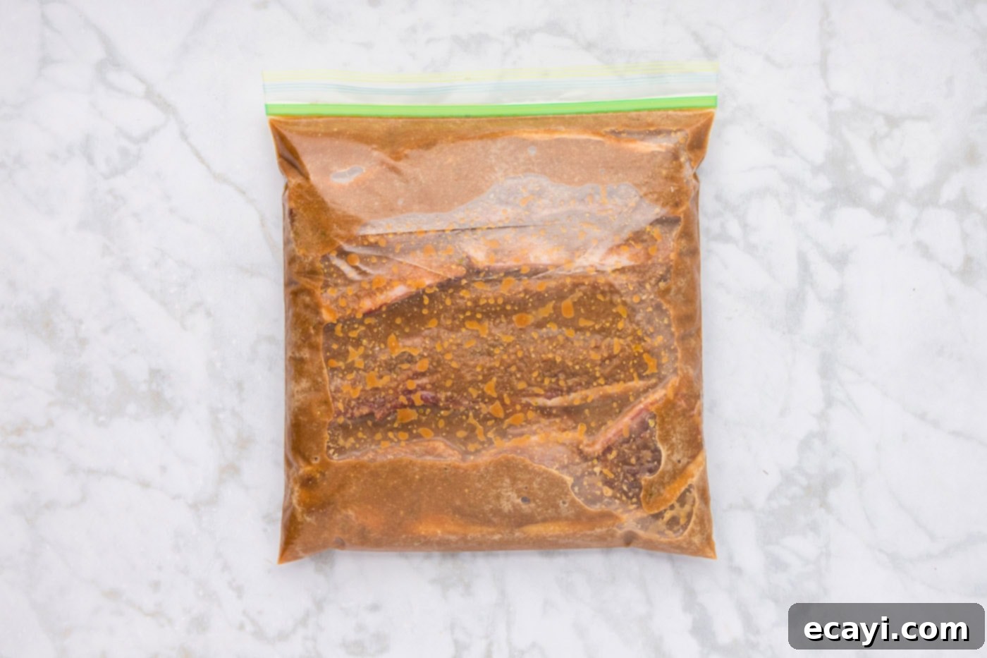Fall-Off-The-Bone Korean Short Ribs 7 Thinly sliced beef short ribs soaking in the rich Korean marinade inside a plastic zip-top bag in the refrigerator.