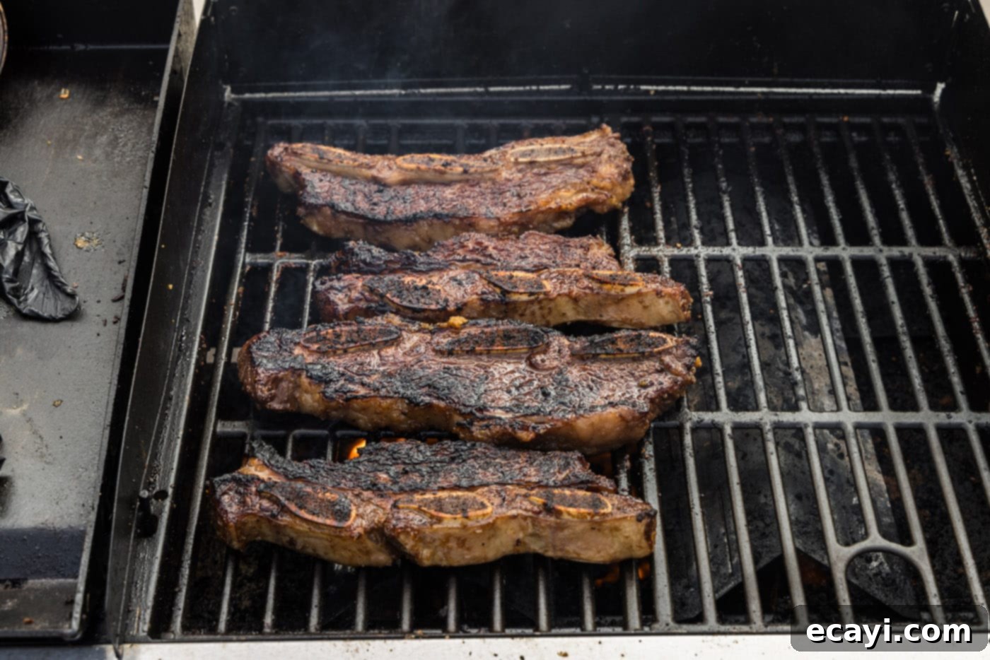 Fall-Off-The-Bone Korean Short Ribs 9 Cooked Korean short ribs on the grill, displaying a beautiful, dark caramelization and tender appearance.