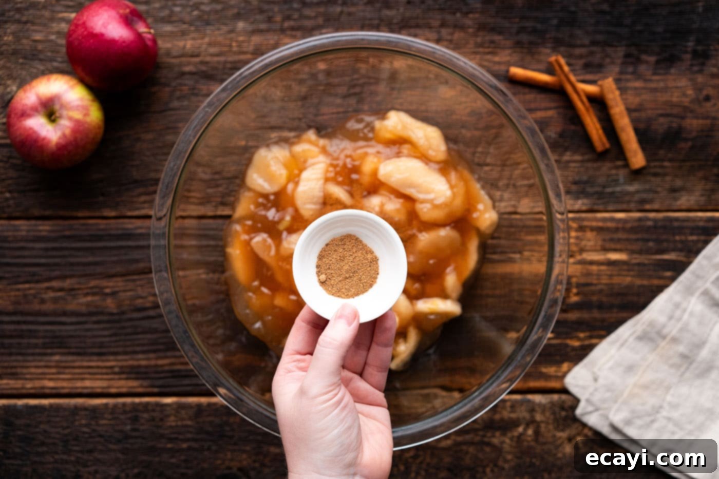 Gooey Caramel Apple Delight 6 adding nutmeg to apple pie filling