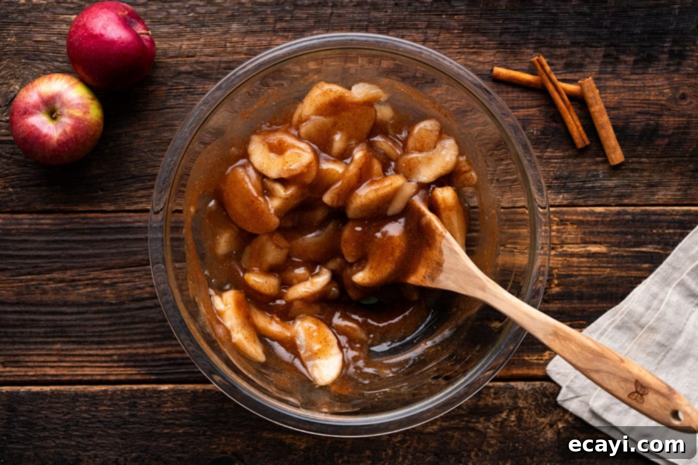 Gooey Caramel Apple Delight 7 apple pie filling in a bowl with a wooden spoon
