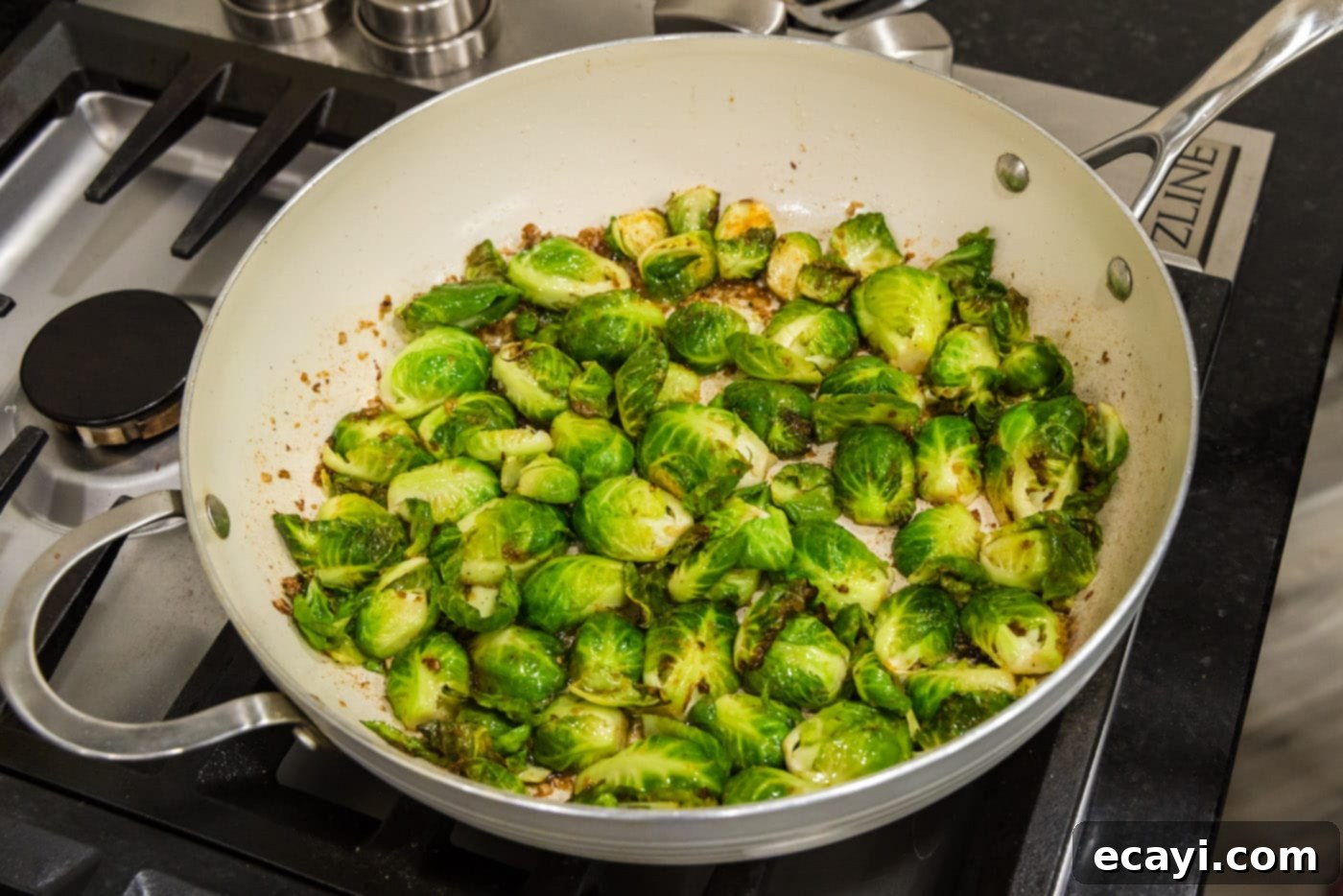 Roasted Brussels Sprouts with Crispy Bacon and Glazed Pecans 13 Brussels sprouts cooking in a skillet, cut side down for caramelization.