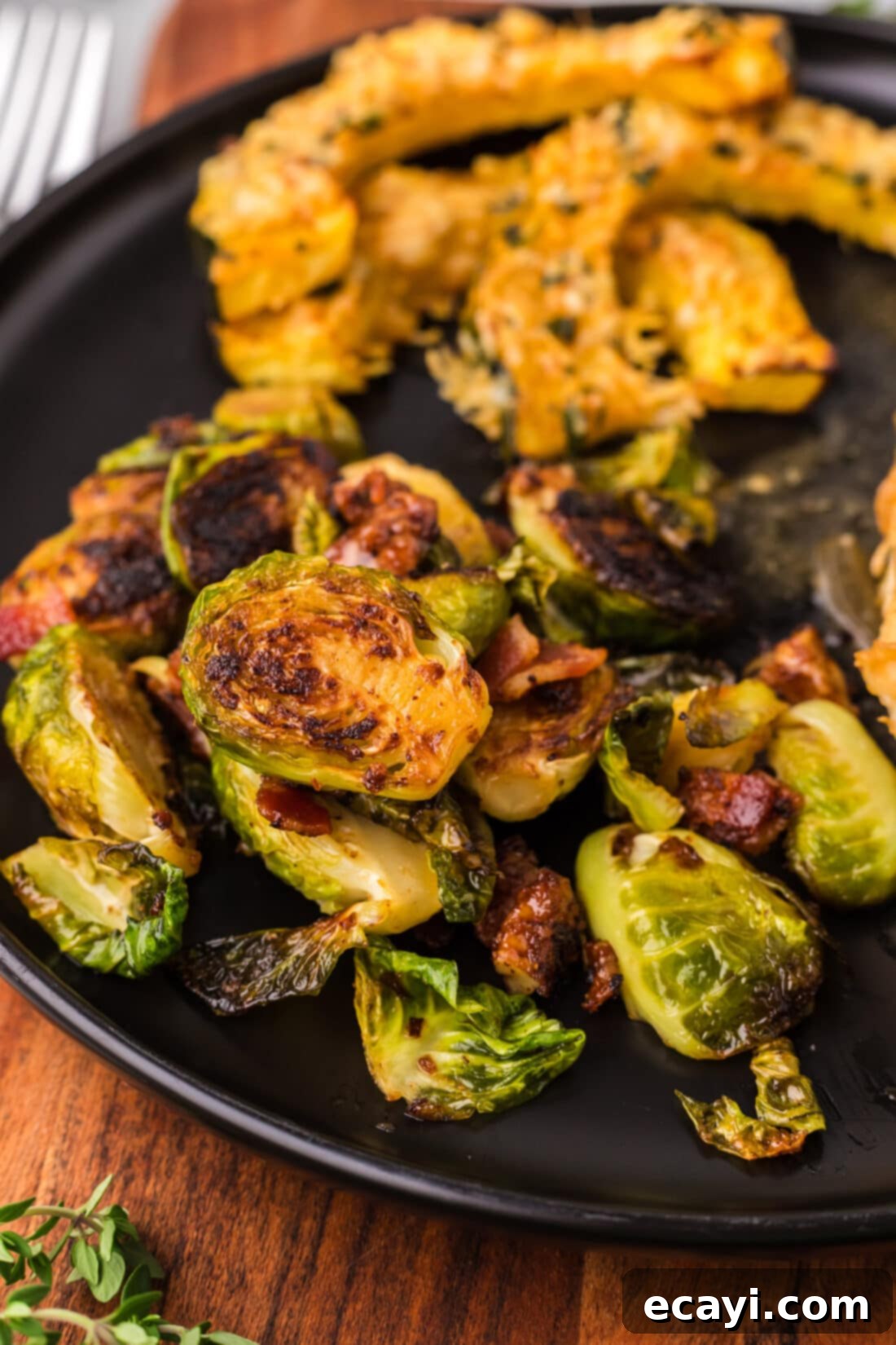 Roasted Brussels Sprouts with Crispy Bacon and Glazed Pecans 19 Brussels Sprouts with Bacon, Shallots and Candied Pecans on a plate alongside Air Fryer Acorn Squash, showcasing a delicious meal.
