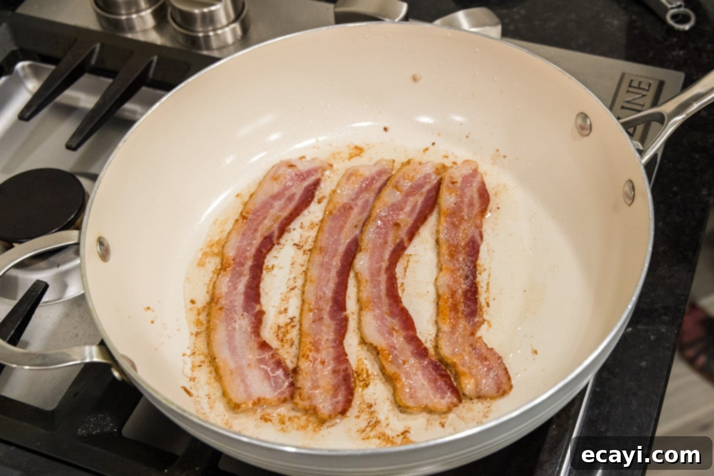 Roasted Brussels Sprouts with Crispy Bacon and Glazed Pecans 9 Cooked bacon strips in a skillet, nearly crispy and ready to be removed.