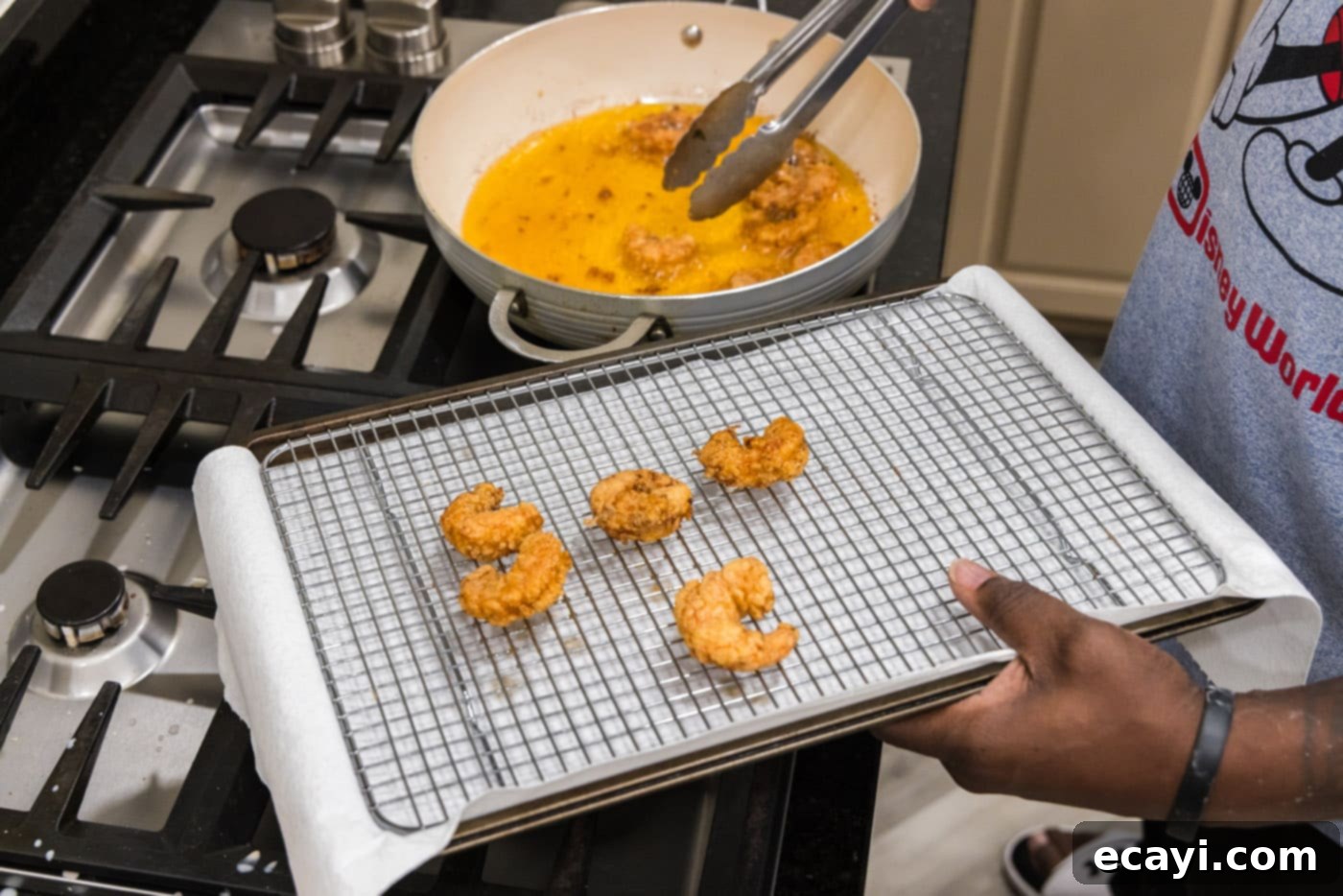 Bang Bang Shrimp 11 tongs removing fried shrimp from oil
