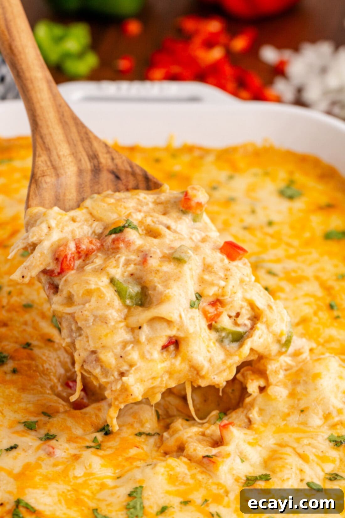 Comforting King Ranch Chicken Casserole 2 A serving of King Ranch Chicken Casserole being lifted out of the pan with a spatula, showcasing its cheesy layers.