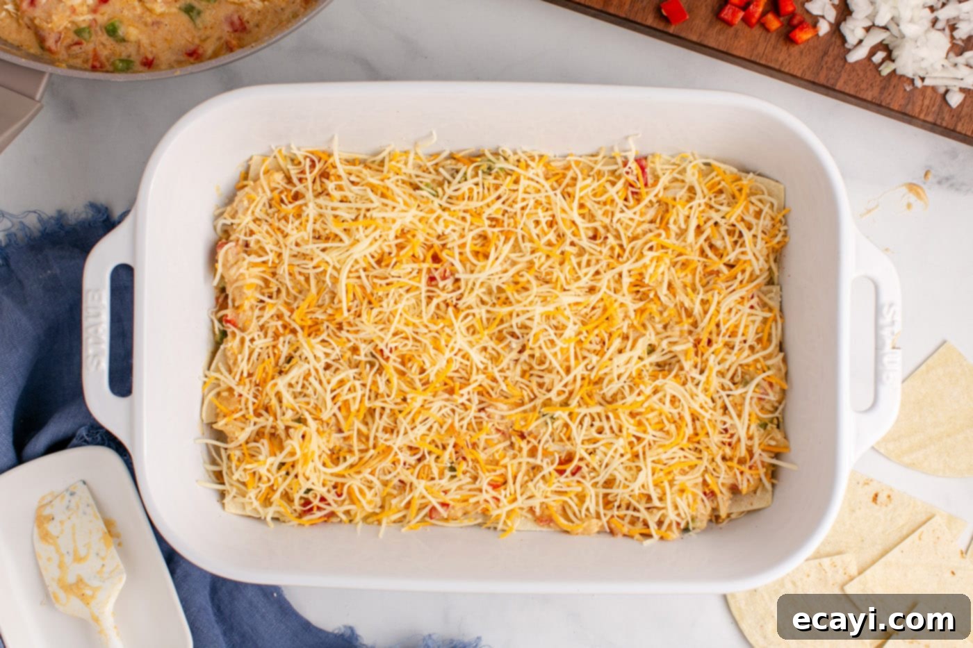 Comforting King Ranch Chicken Casserole 14 Shredded cheese generously sprinkled over the chicken and sauce layer in the baking dish.