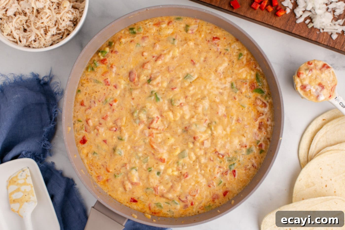 Comforting King Ranch Chicken Casserole 8 The creamy King Ranch sauce simmering in a skillet, showcasing its rich texture.