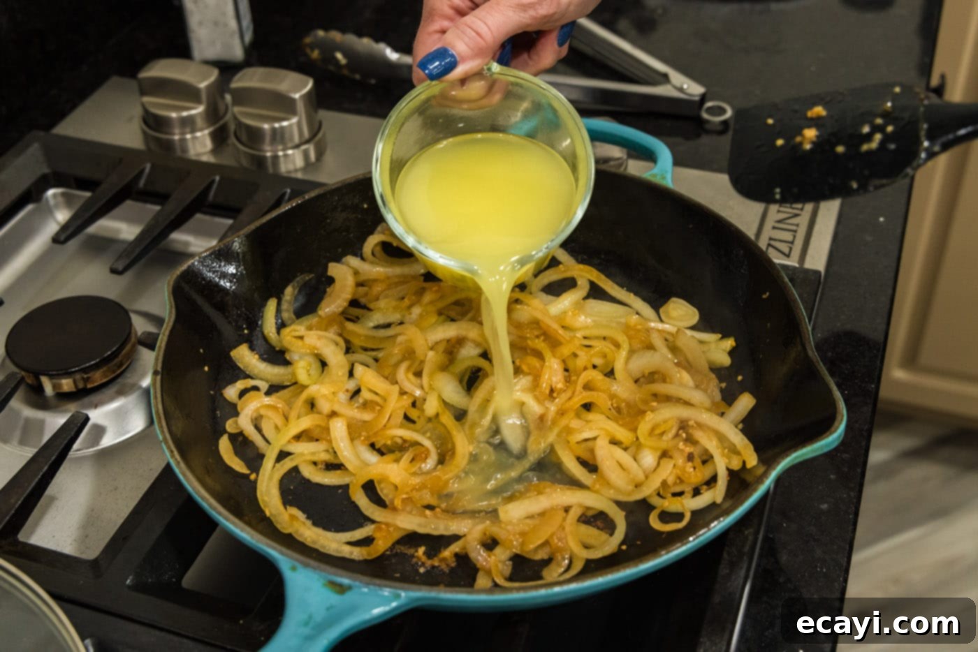Savory Onion-Thyme Chicken 13 pouring chicken broth into skillet with onions