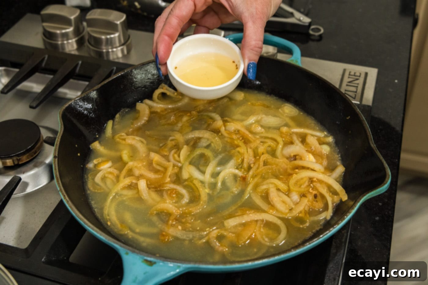 Savory Onion-Thyme Chicken 14 pouring rice vinegar into skillet with onions and chicken broth