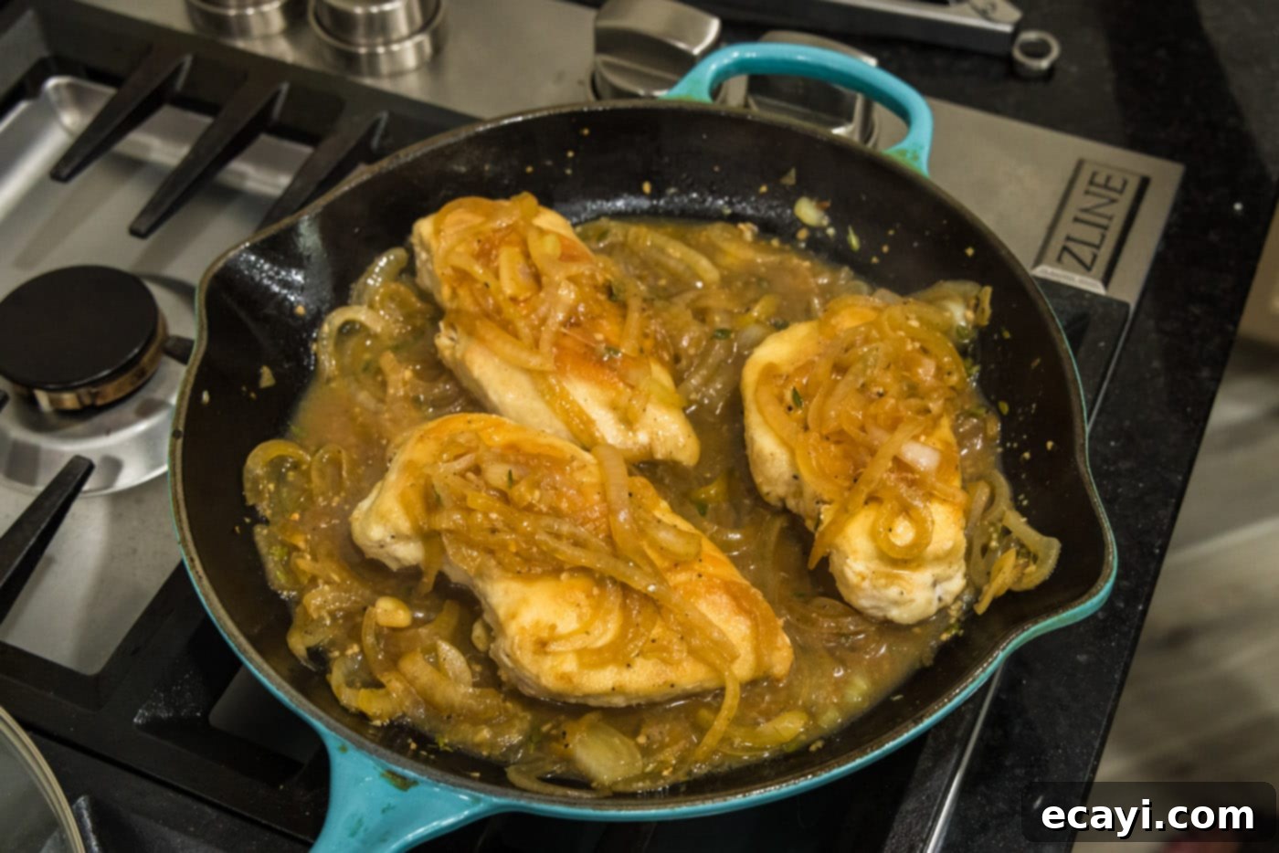 Savory Onion-Thyme Chicken 17 chicken breasts in a skillet with onion thyme sauce