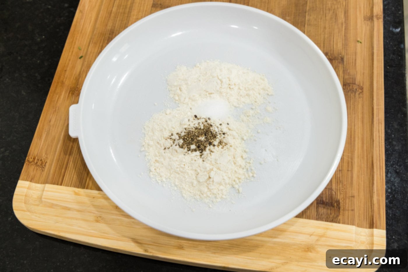 Savory Onion-Thyme Chicken 5 flour with salt and pepper on a plate