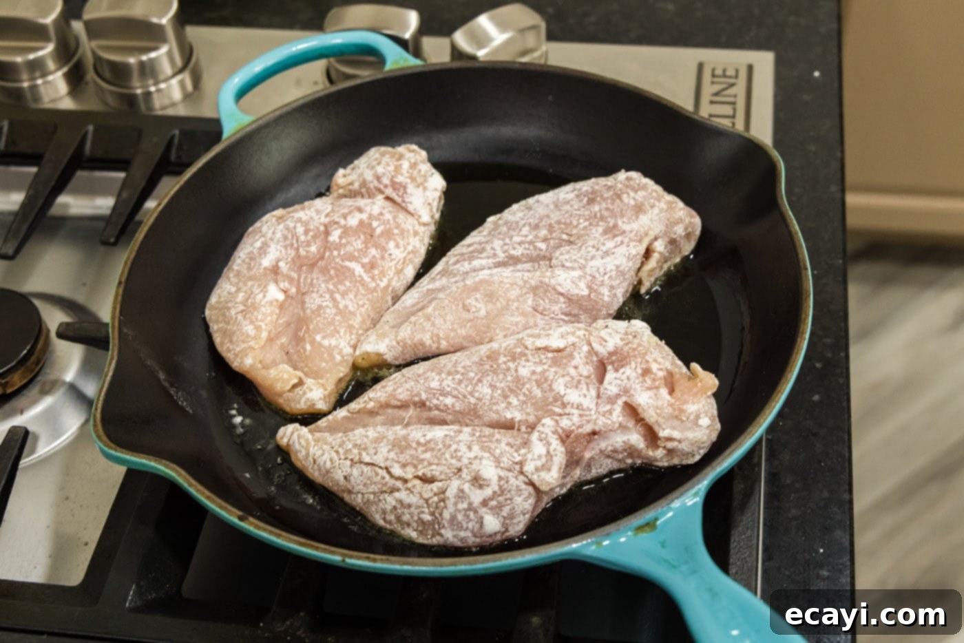 Savory Onion-Thyme Chicken 9 searing flour coated chicken breasts in a skillet