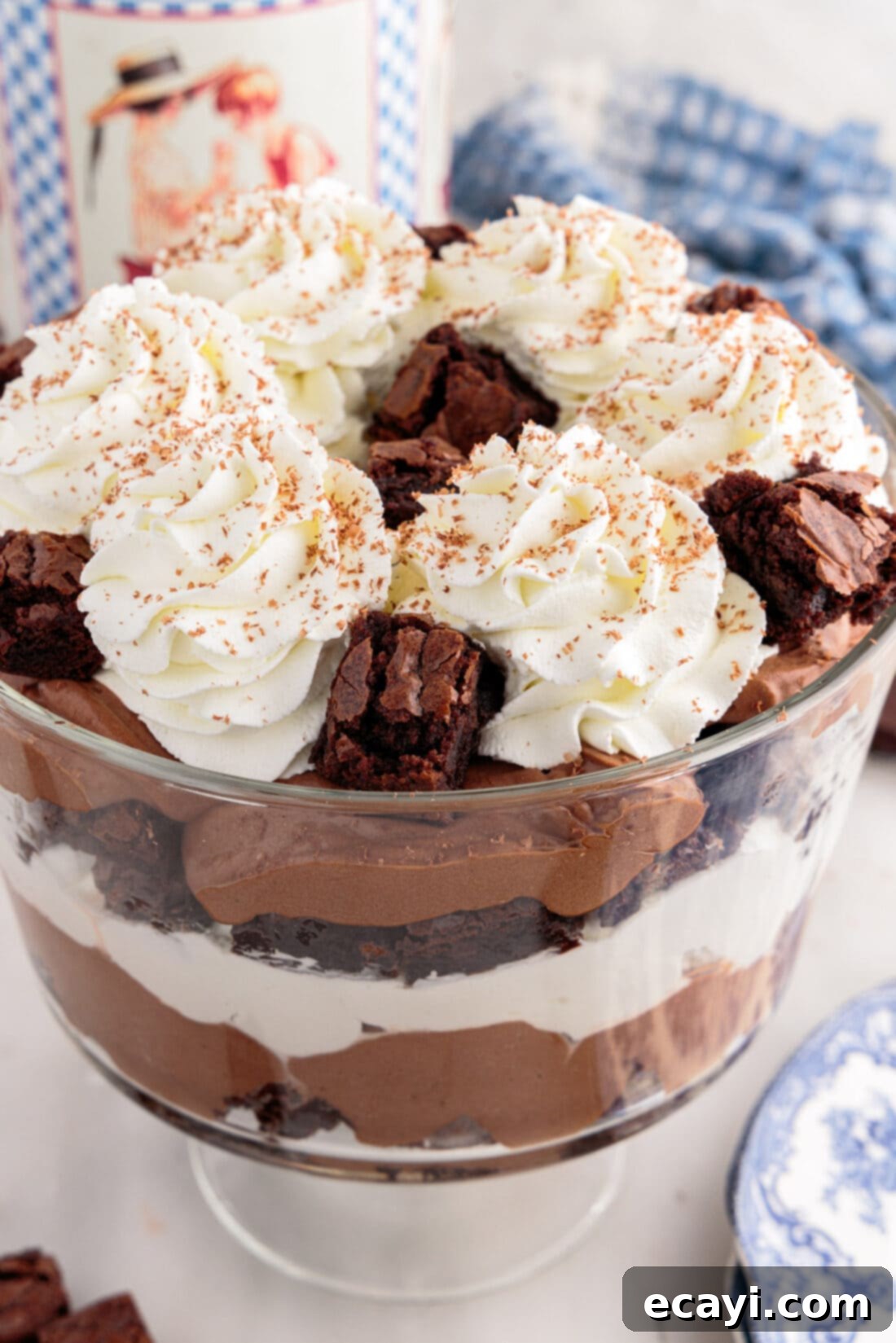 Decadent Brownie Trifle 2 Close up view of a decadent Brownie Trifle, showcasing layers of fudgy brownies, creamy chocolate pudding, and whipped topping, ready to be served.